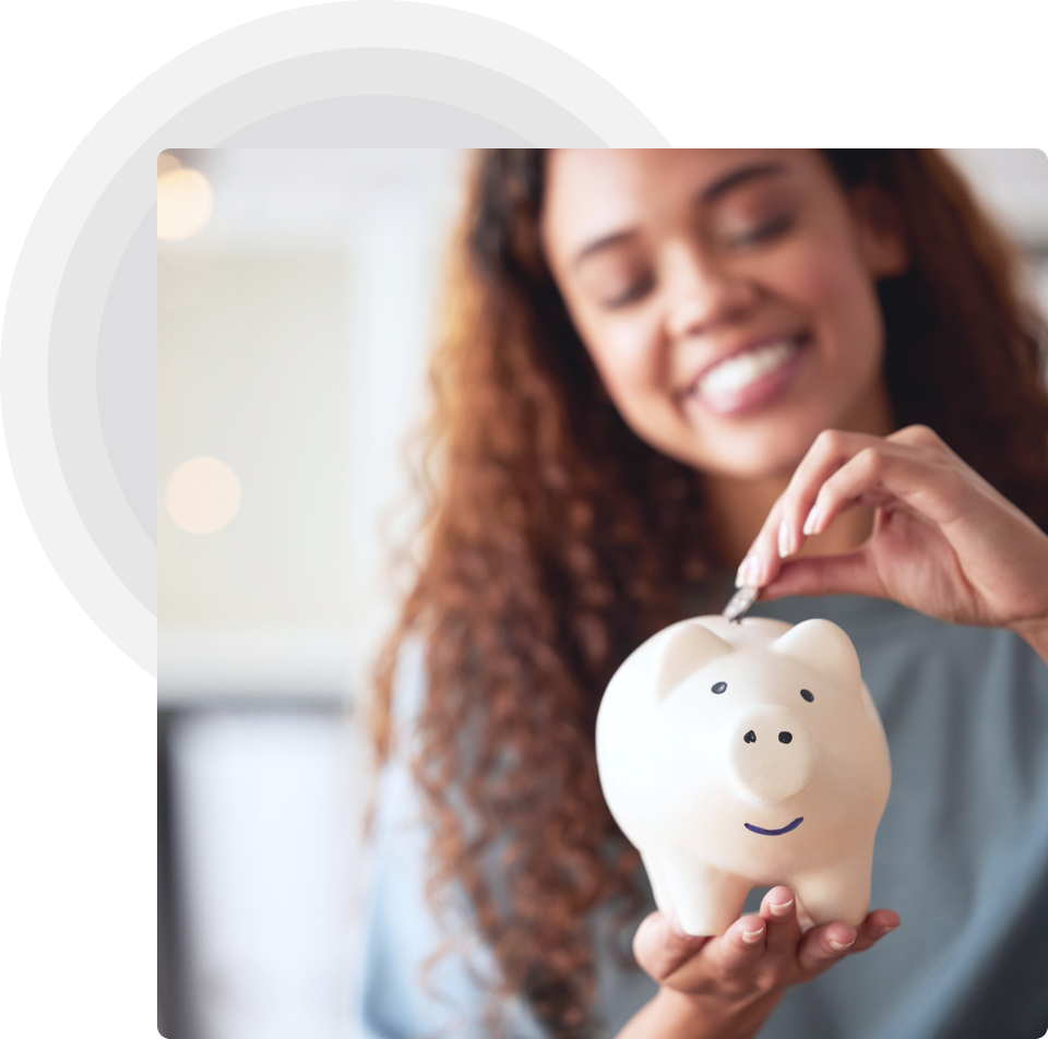 Young girl happily saving coins in a piggy bank, learning financial responsibility